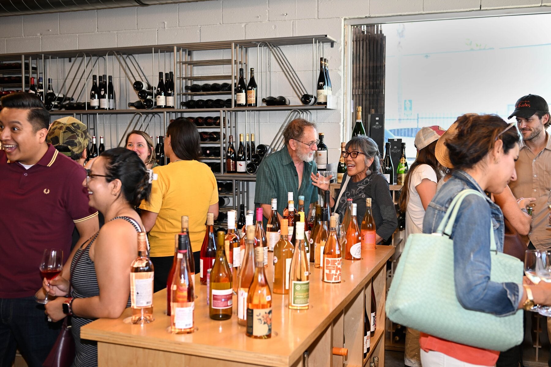 The bar lined with rosé bottles and a crowd behind