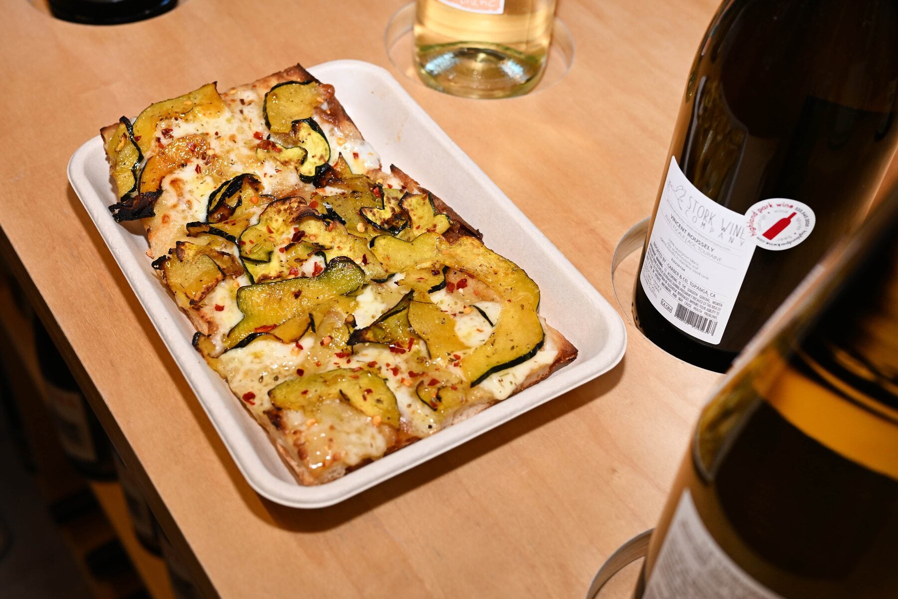 A Triple Beam pizza moment with wine glasses
